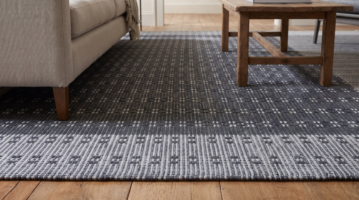 Clara Xena Charcoal Flatweave Wool &amp; Cotton Rug in a living room