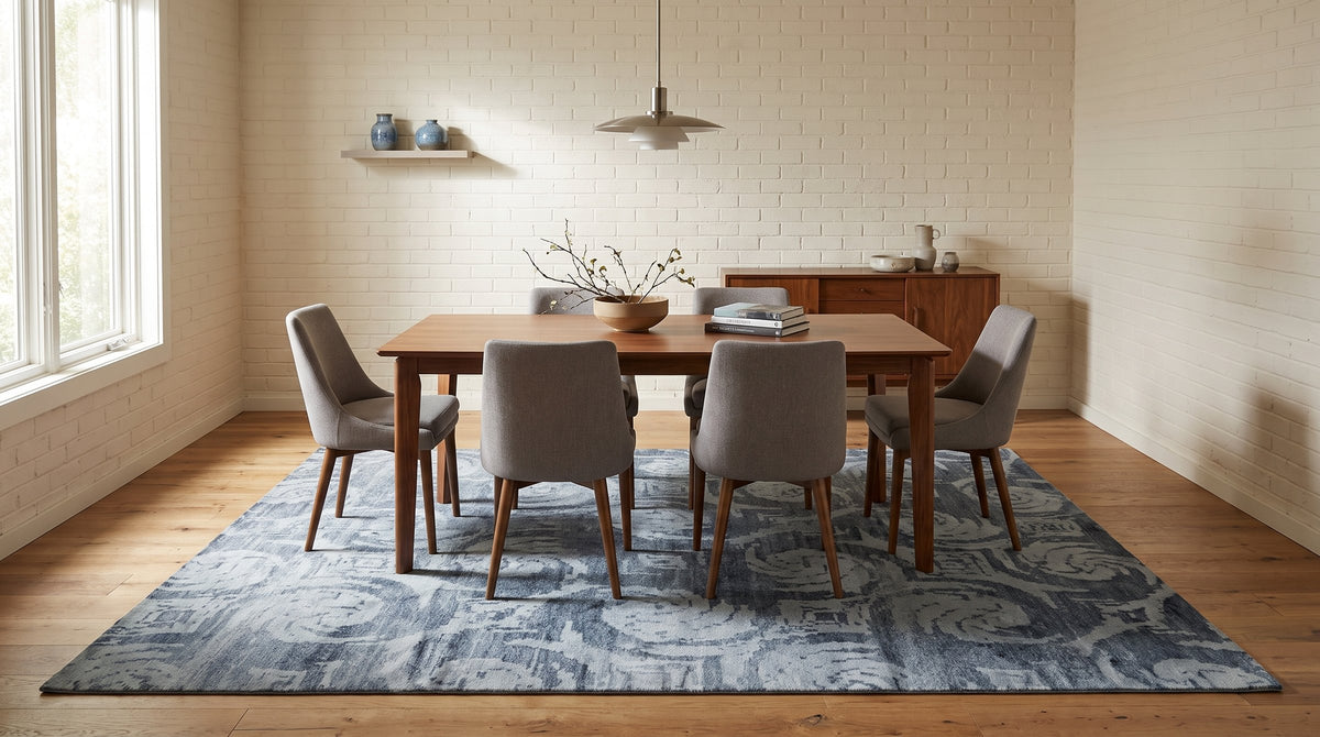 Comfortable Nina Gray and Blue Hand Knotted Wool & Bamboo Silk Rug in a dining room