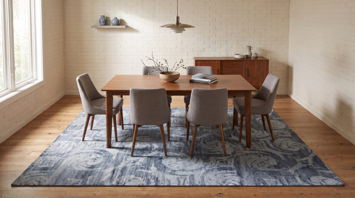Comfortable Nina Gray and Blue Hand Knotted Wool & Bamboo Silk Rug in a dining room