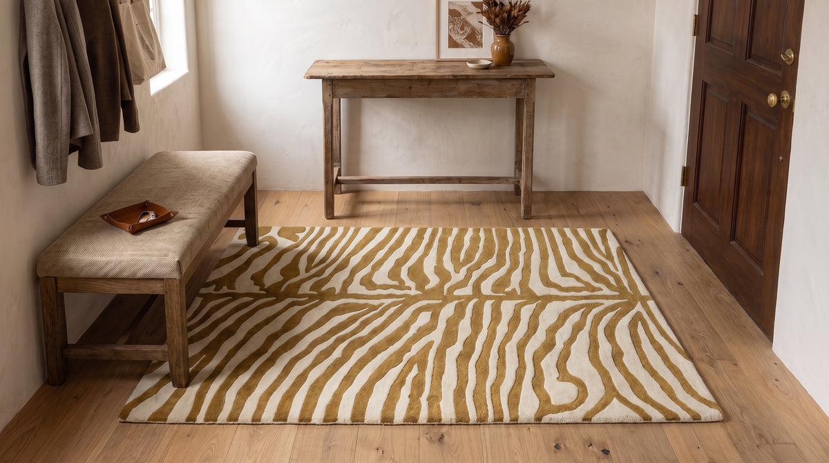 Dahlia Sleek Gold Hand Tufted Wool Rug in a entryway