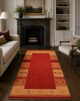 Handloomed Red Gabbeh Tribal Wool Area Rug in a styled room (4)