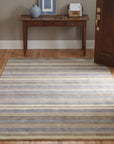Ella Rustic Brown and Blue Handmade Wool Rug in a entryway