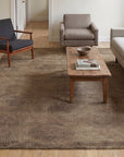 Exquisite Yara Brown Hand Knotted Wool Rug in a living room