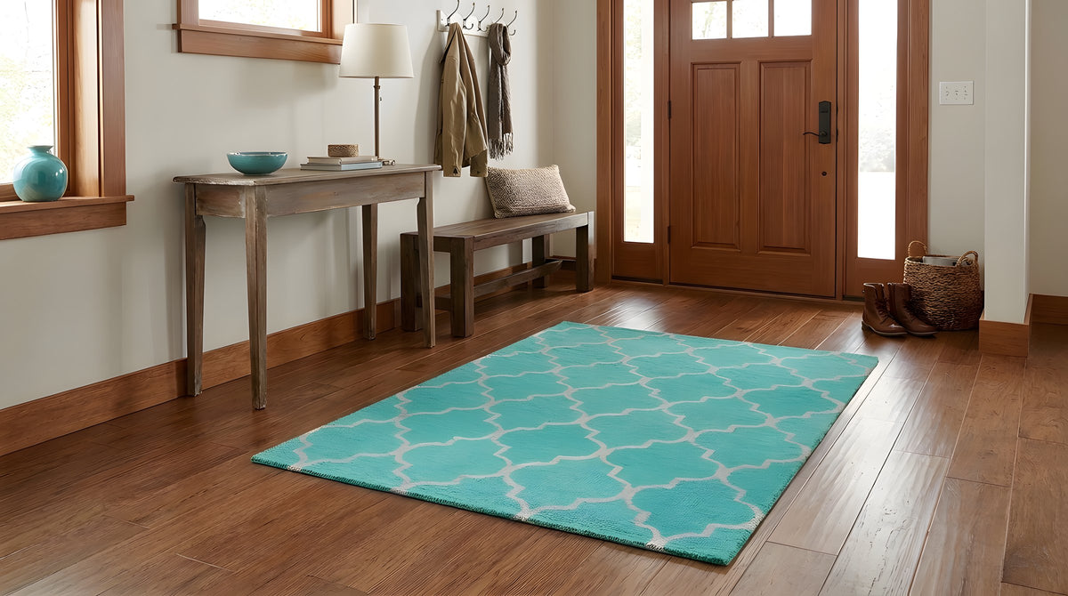 Giselle Moroccan Teal Green Hand Tufted Wool Rug in a entryway