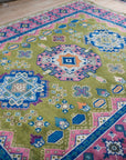 Green and fuchsia Kazak hand-knotted rug, angled view showing medallions