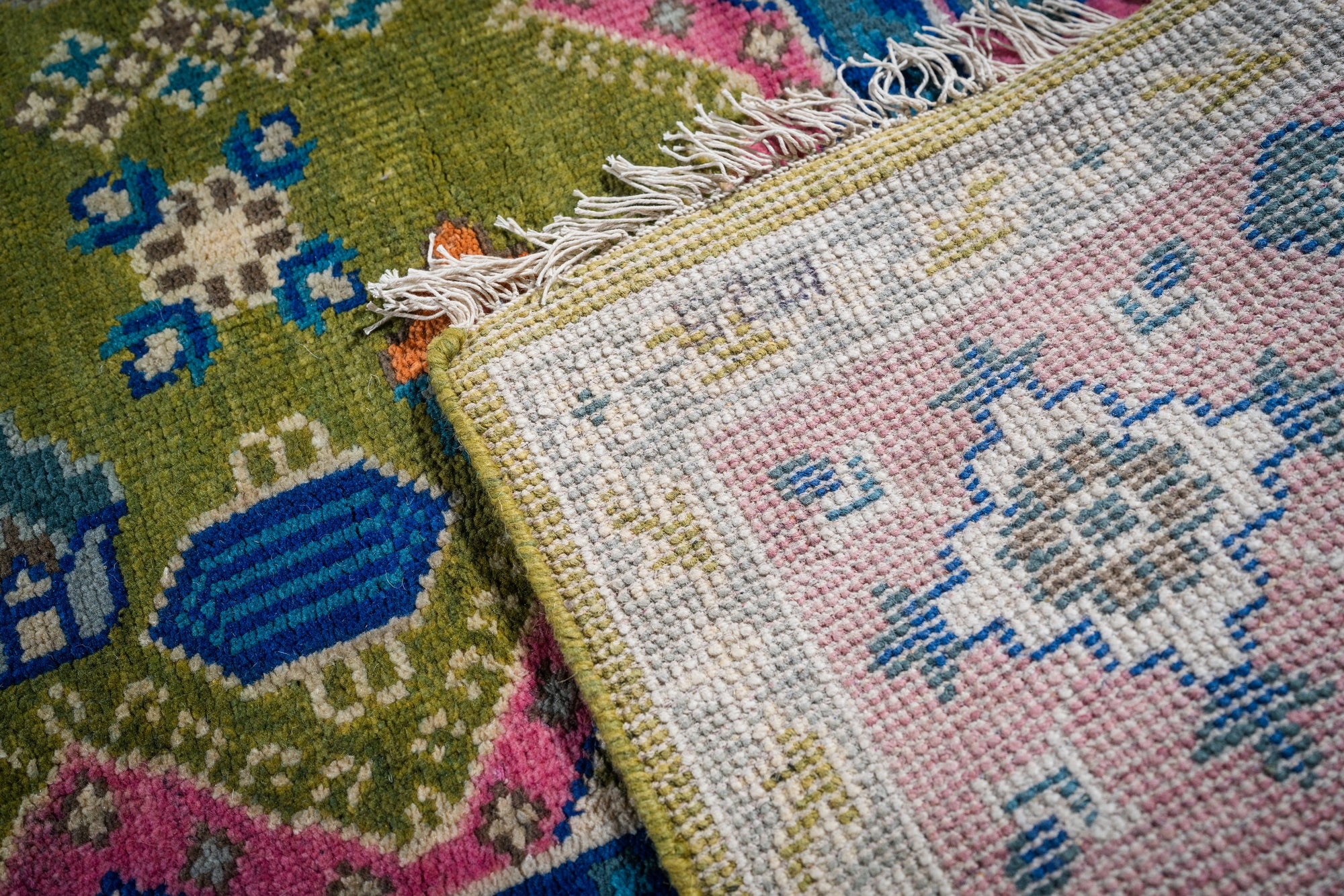 Green and fuchsia Kazak rug hand-knotted back and pile detail