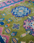 Green and fuchsia Kazak rug medallion detail