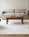 Handcrafted Artisan Ivory Hand Tufted Wool Rug in a living room