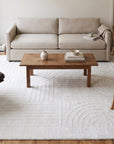 Handcrafted Artisan Ivory Hand Tufted Wool Rug in a living room