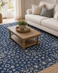 Blue ivory Oushak floral rug styled in a cozy living room