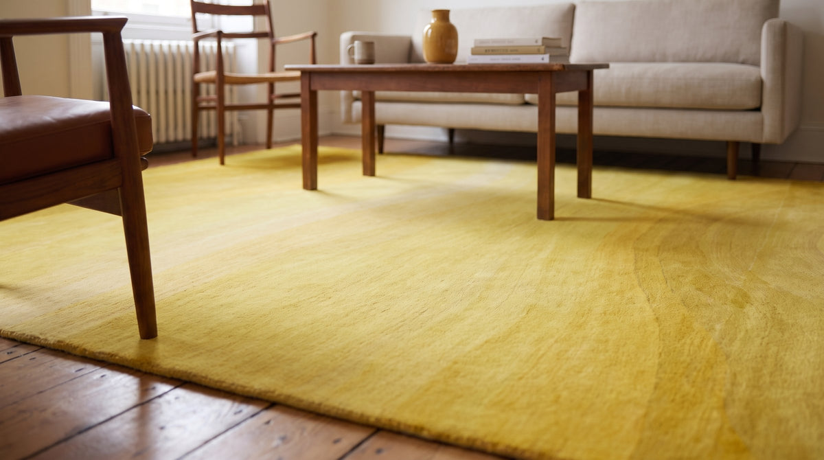 Inviting Ruby Yellow Hand Tufted Wool Rug in a living room