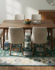 Isla Kazak Green Hand Knotted Wool Rug in a dining room