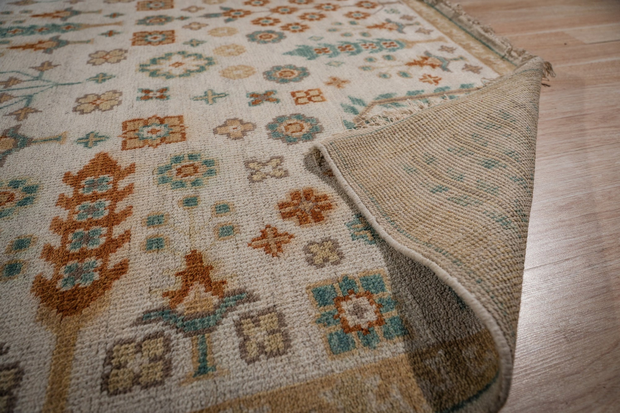 Ivory Oushak rug field and hand-knotted back detail