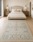 Ivory Oushak floral rug styled in a serene bedroom