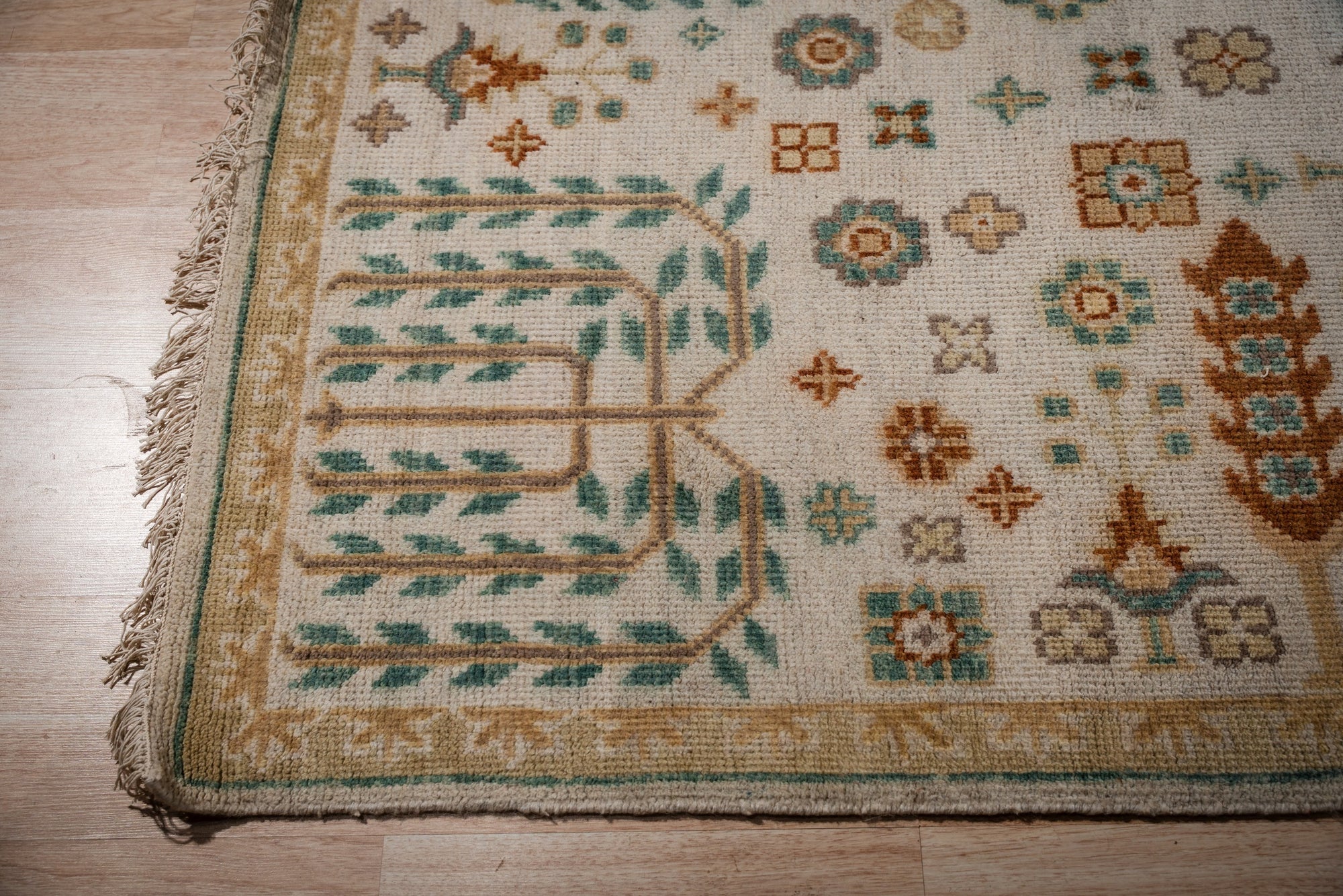 Ivory Oushak rug corner with willow-tree motif