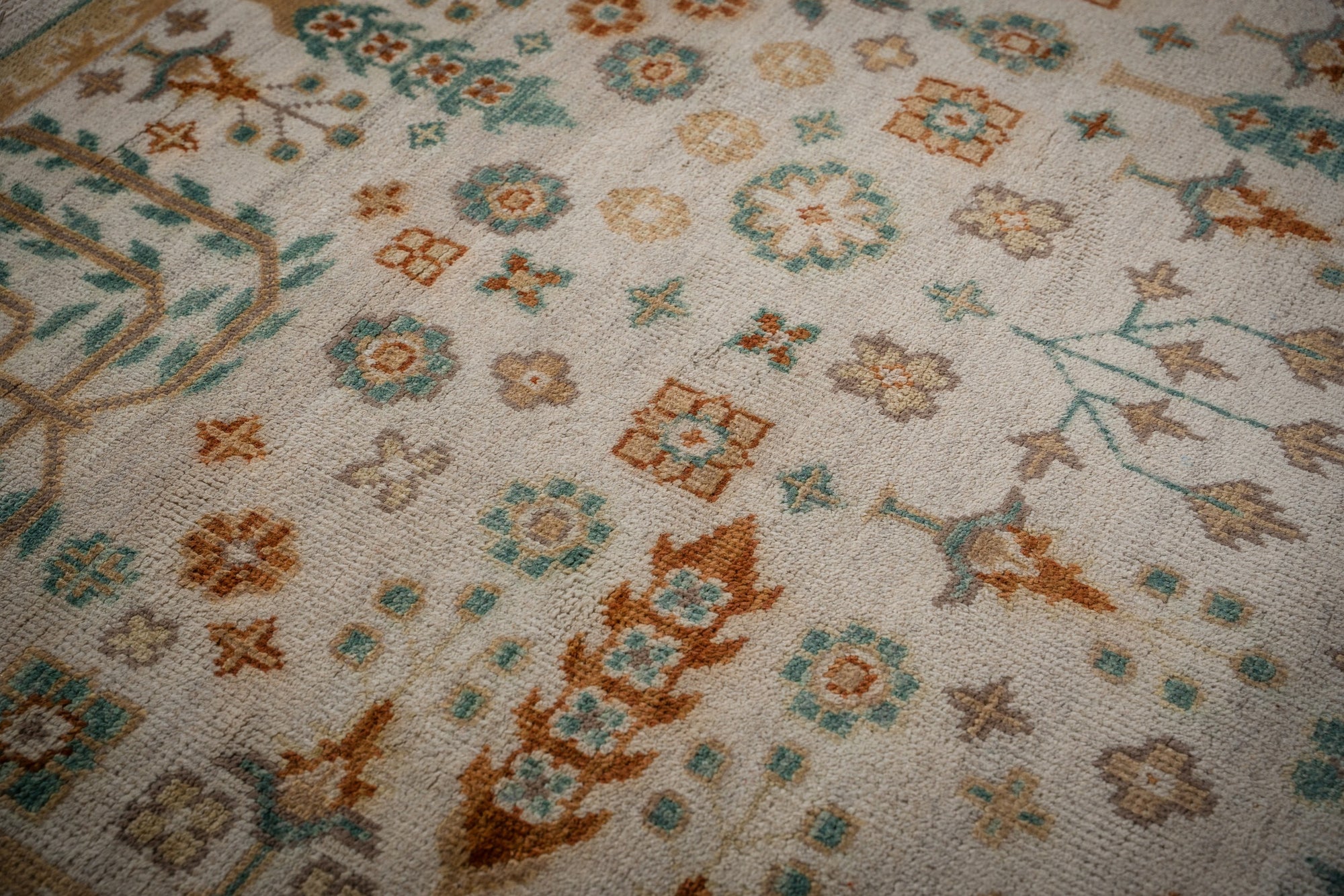 Ivory Oushak rug floral field close-up