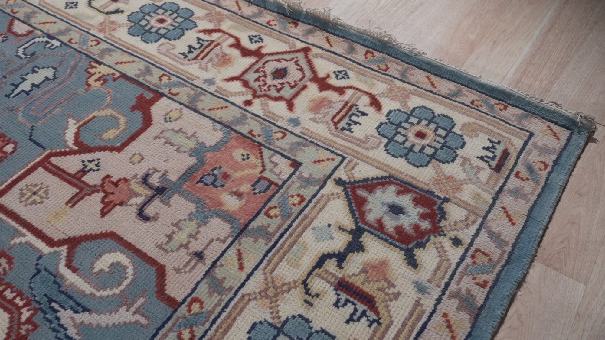 Ivory medallion rug corner and floral border detail