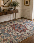 Ivory traditional medallion rug styled in an entryway with a console table