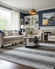 Gray contemporary geometric loom-check wool and viscose area rug styled in a living room