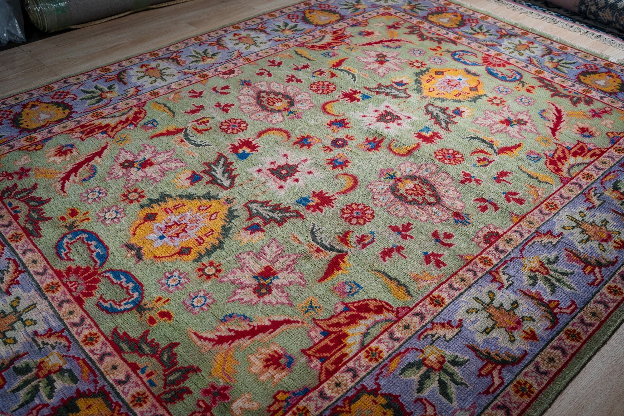 Light green Oushak rug angled full view