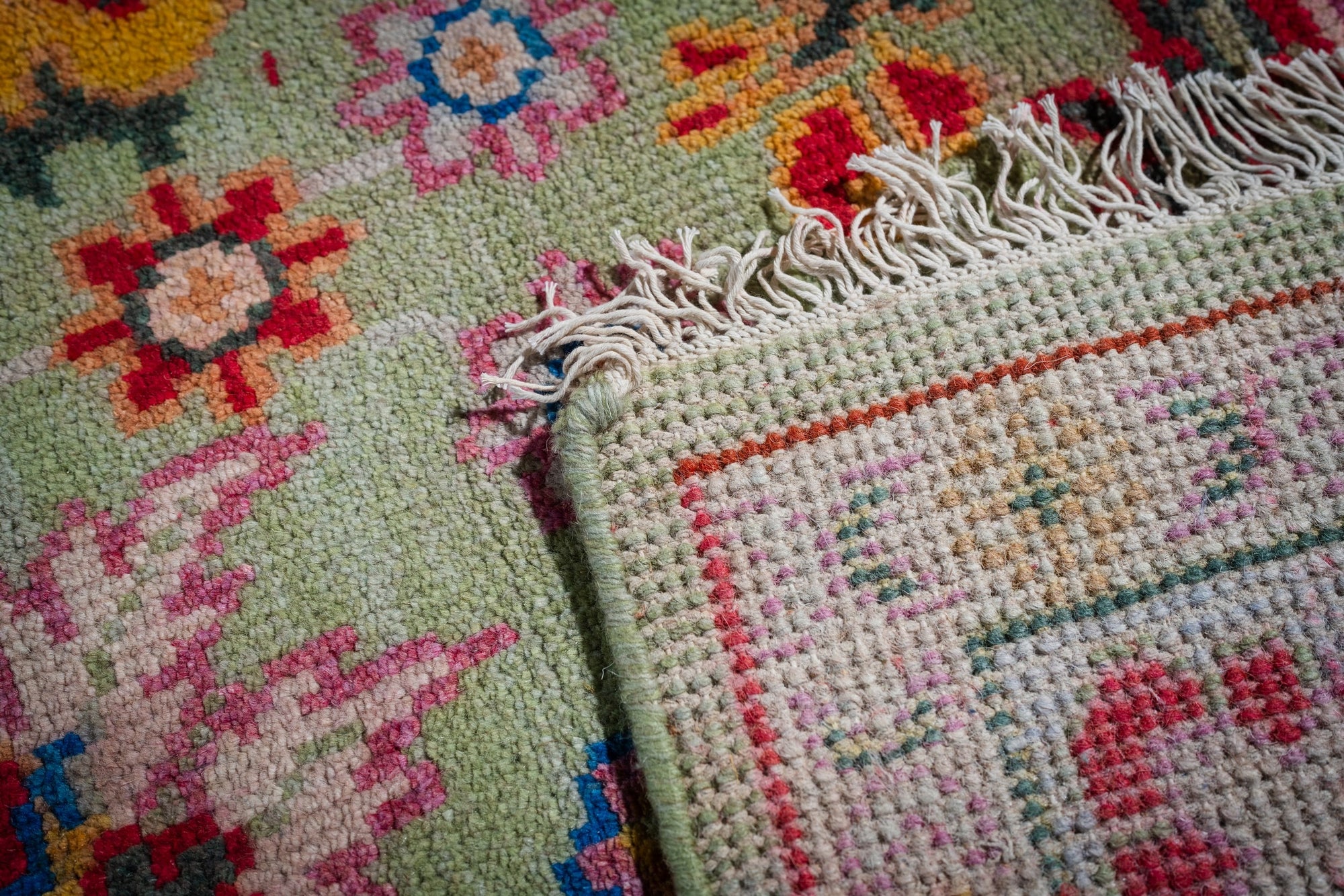 Light green Oushak rug hand-knotted back and fringe detail