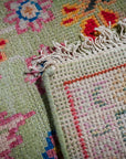 Light green Oushak rug hand-knotted back and fringe detail