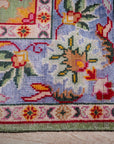 Light green Oushak rug corner and periwinkle border detail