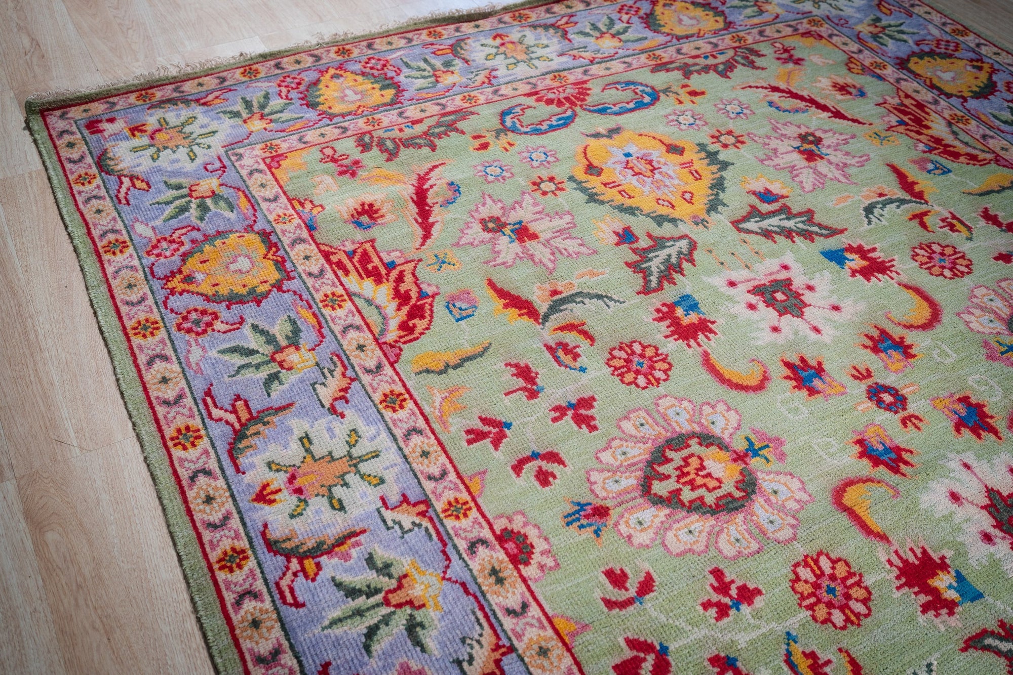 Light green Oushak rug field and border detail