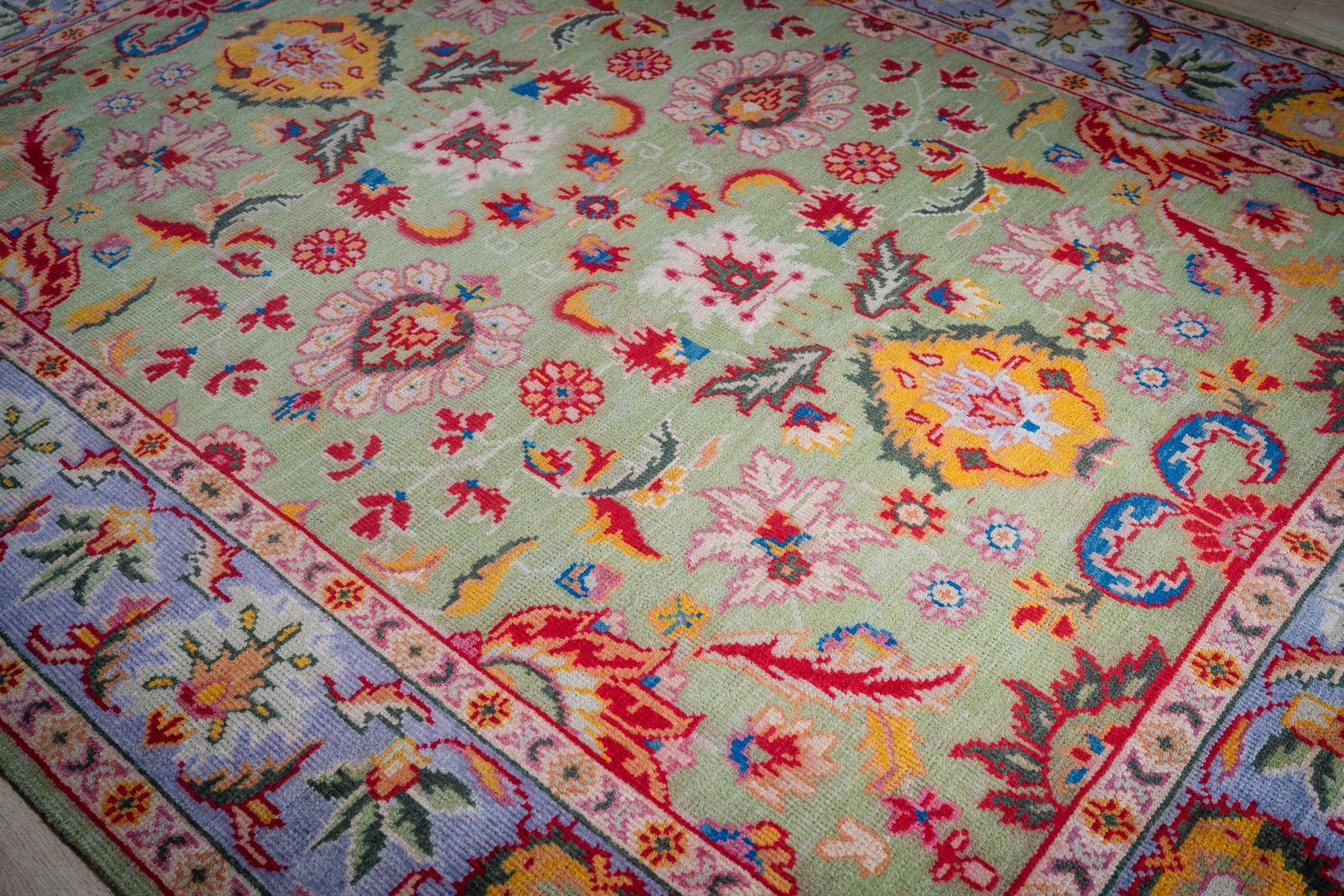 Light green Oushak rug floral field close-up