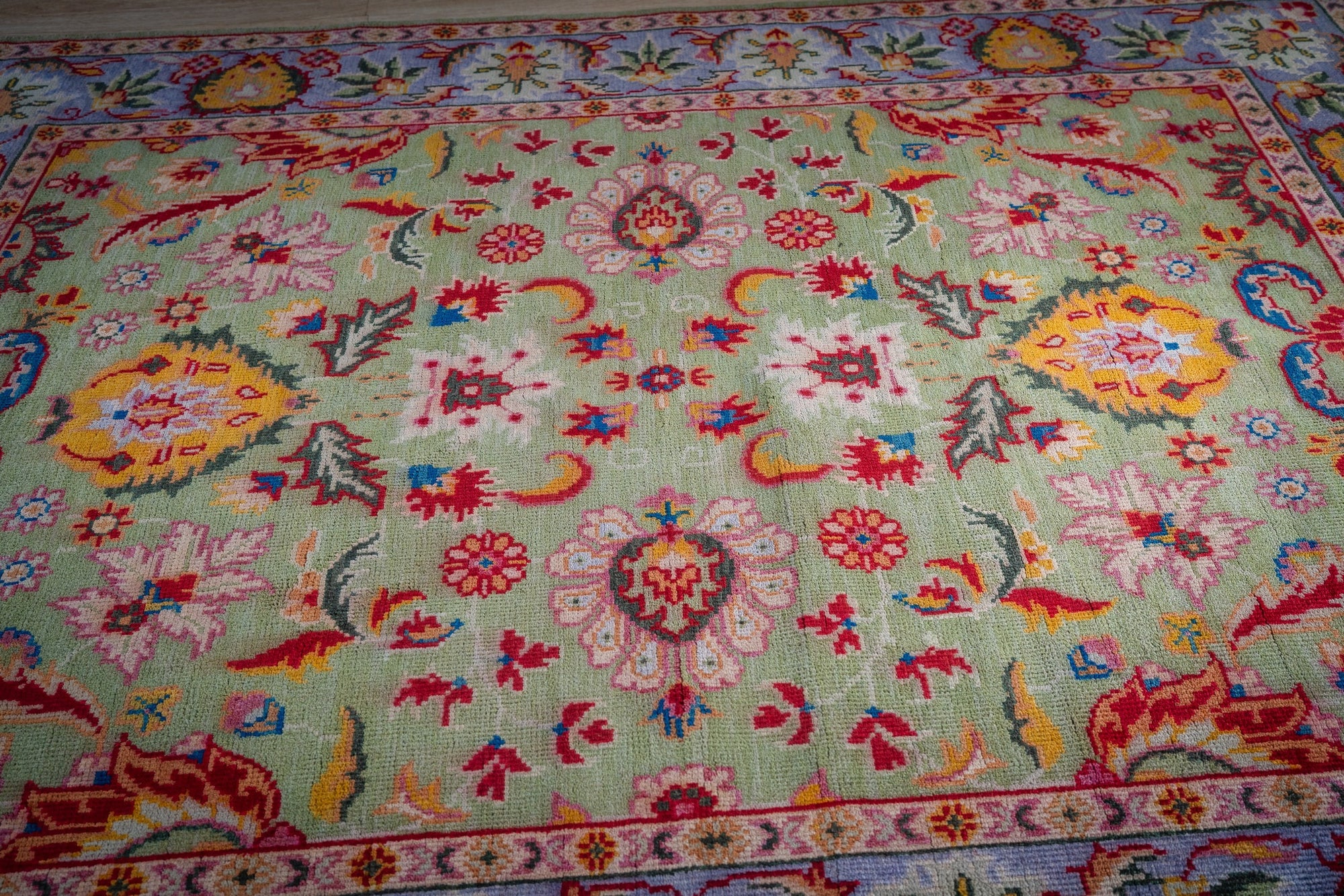 Light green Oushak rug top-down field detail