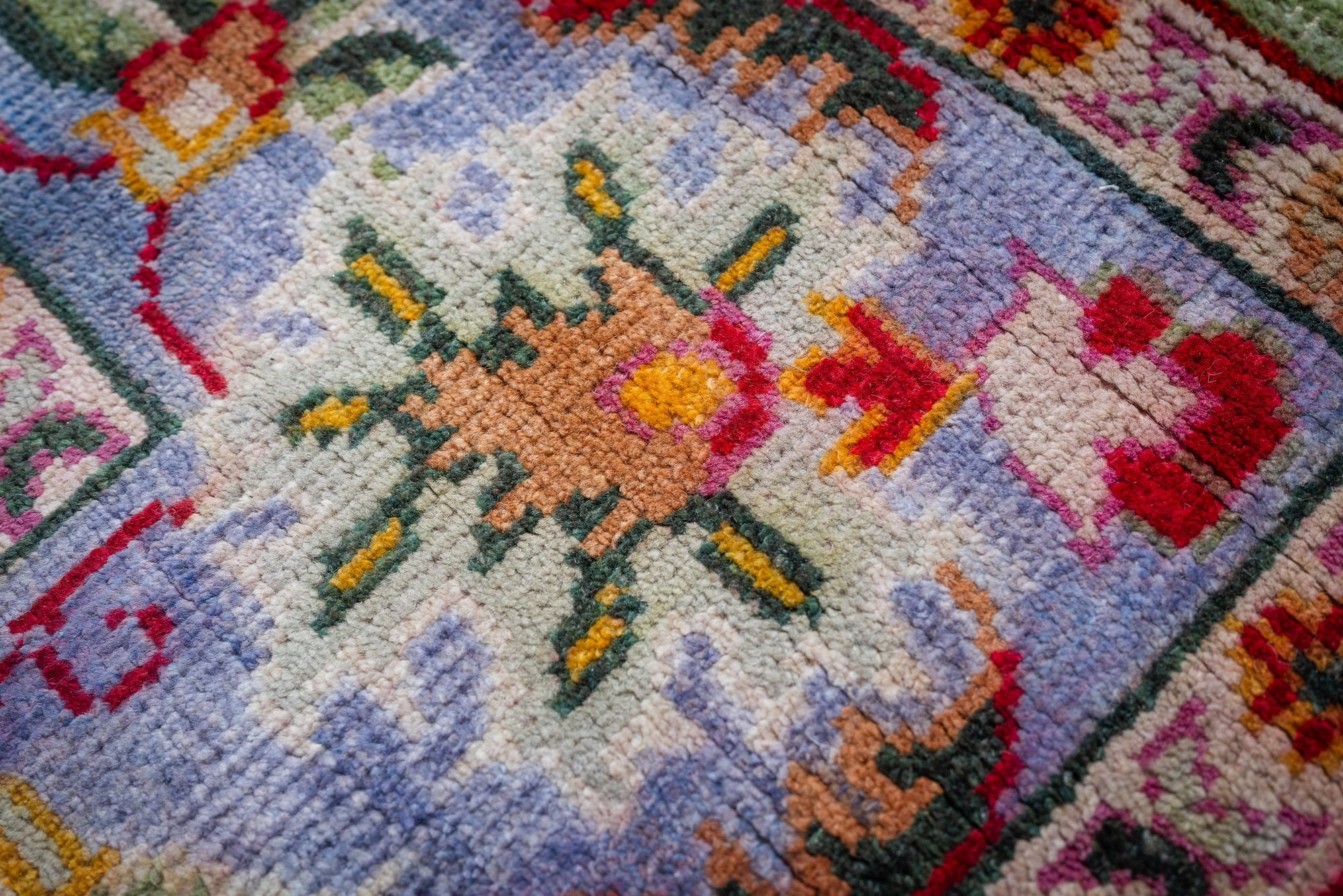 Light green Oushak rug floral motif close-up
