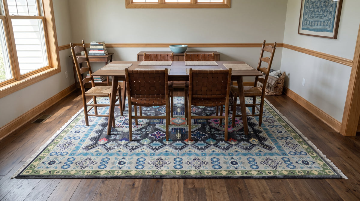 Maya Kazak Charcoal and Ivory Hand Knotted Wool Rug in a dining room