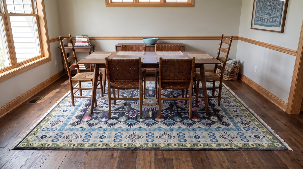 Maya Kazak Charcoal and Ivory Hand Knotted Wool Rug in a dining room