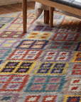 Nadia Kilim Multicolor Flatweave Wool Rug in a bedroom