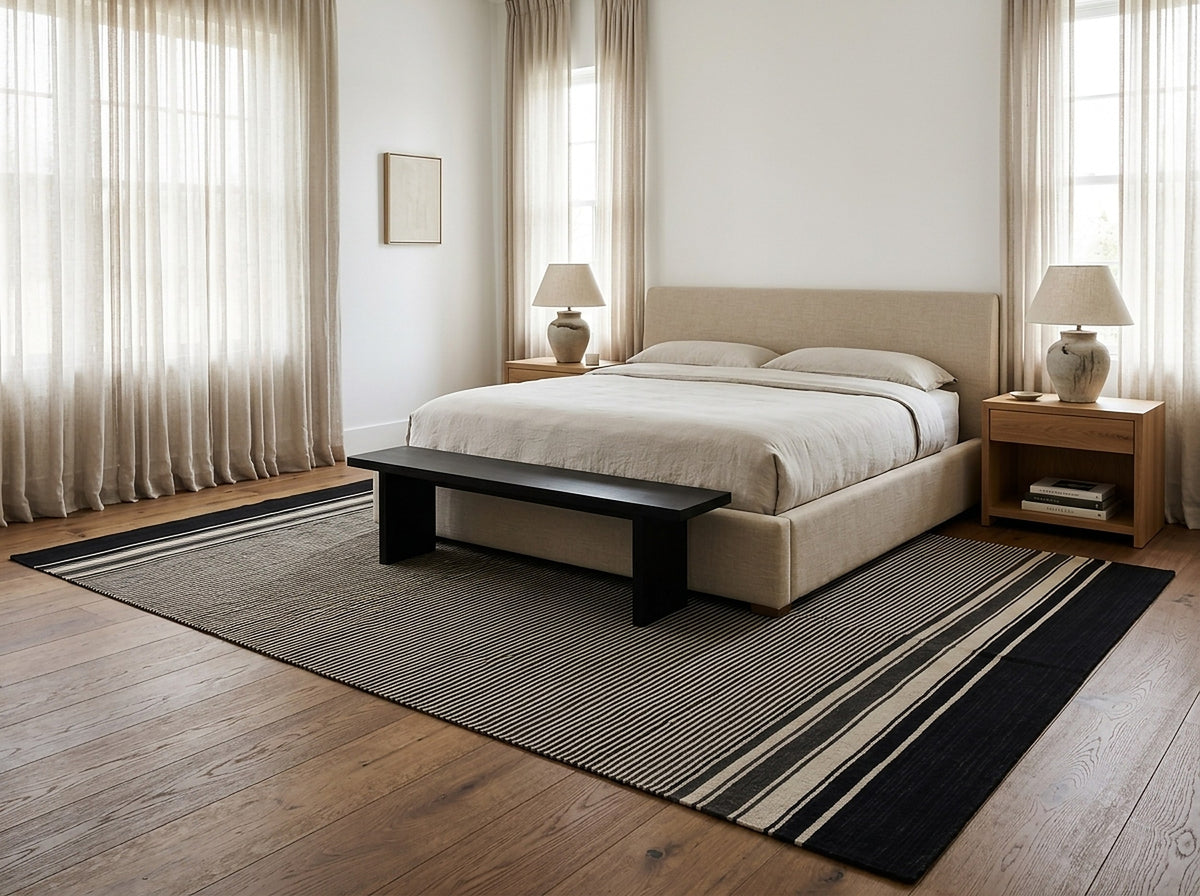 Black and Beige Stripe Handmade Wool Rug styled in a bedroom