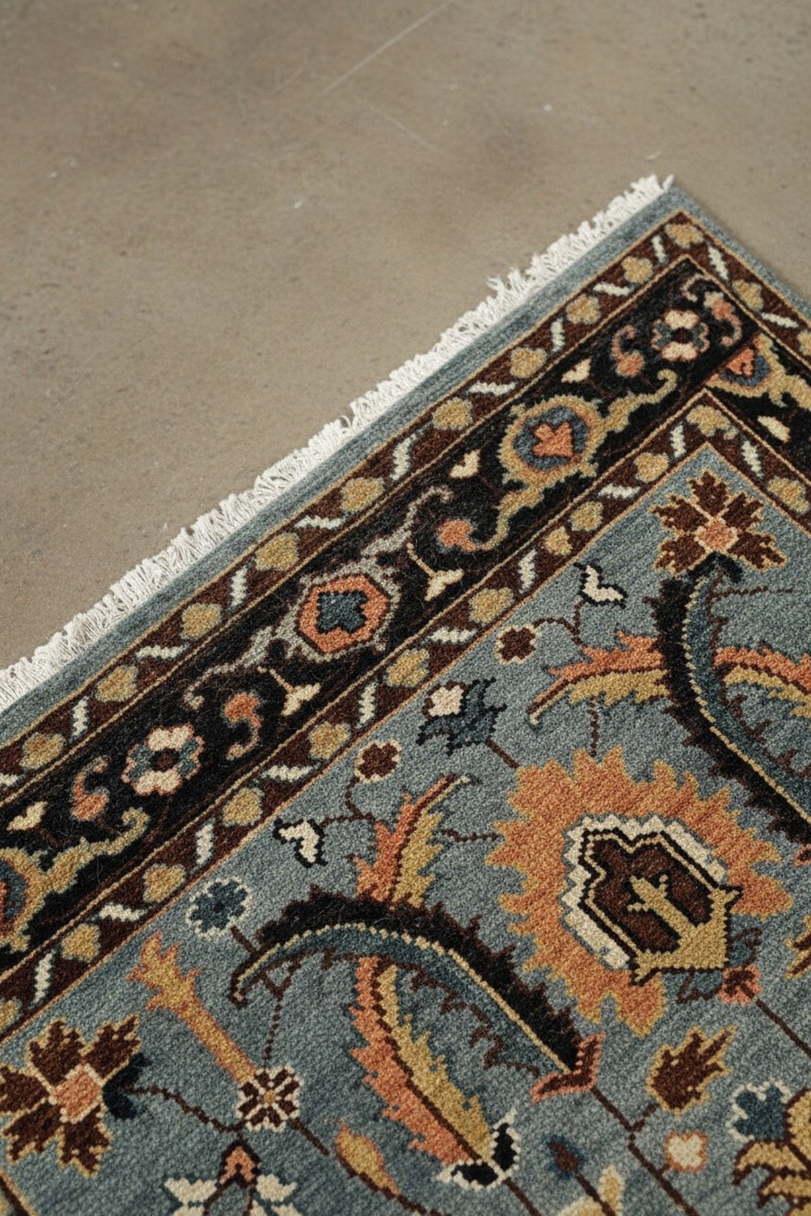 Gray and navy traditional hand-knotted wool rug KR110GY shown in a styled interior setting