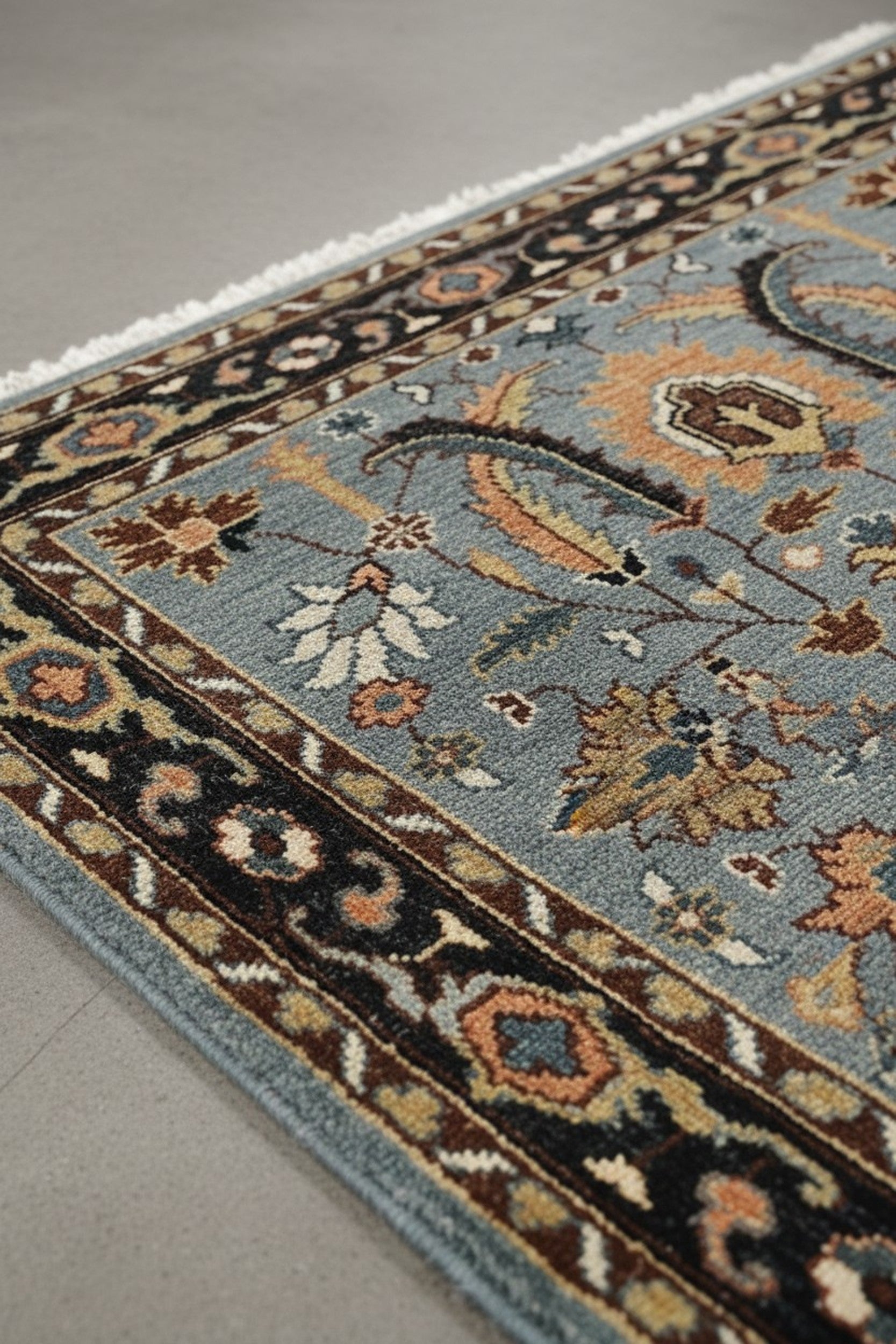 Gray and navy traditional hand-knotted wool rug KR110GY in a decorated room