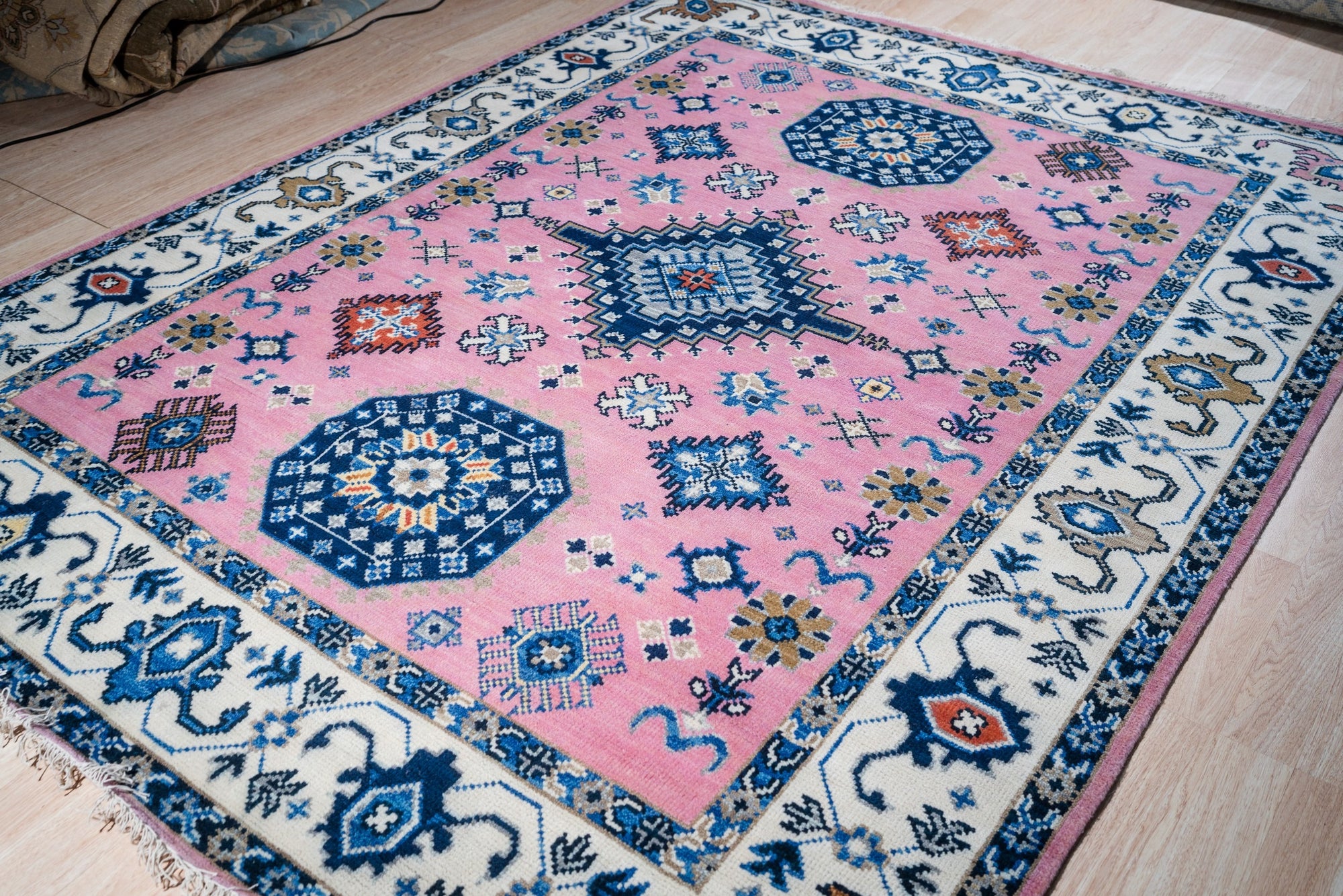 Pink ivory Kazak rug angled full view