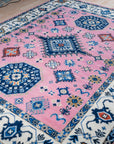 Pink ivory Kazak rug angled full view