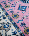 Pink ivory Kazak rug corner and border detail