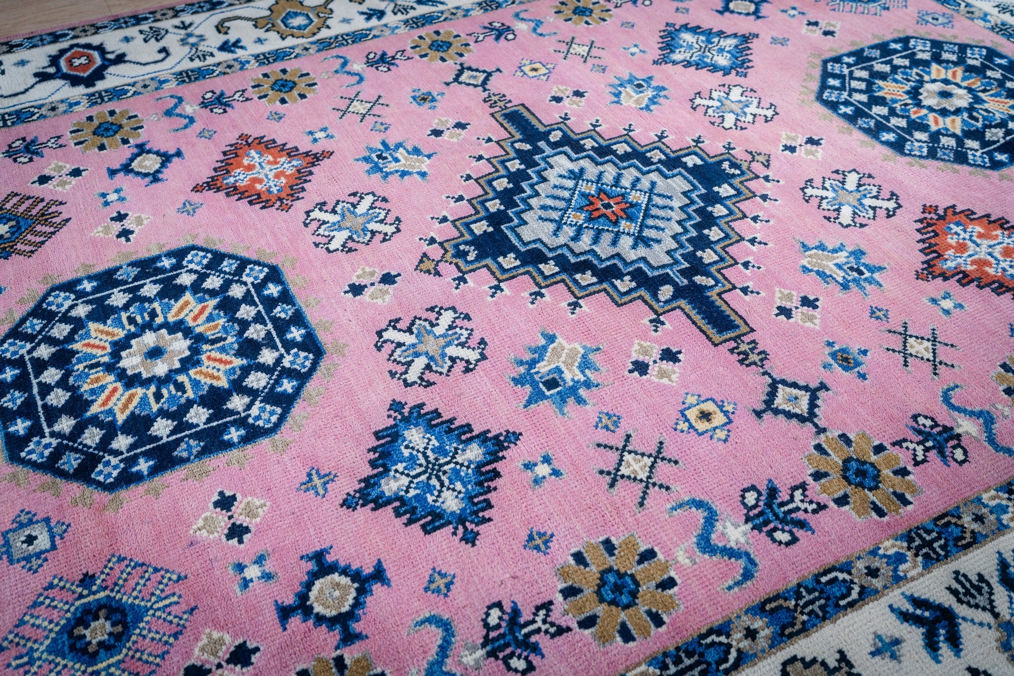 Pink ivory Kazak rug field and medallion detail