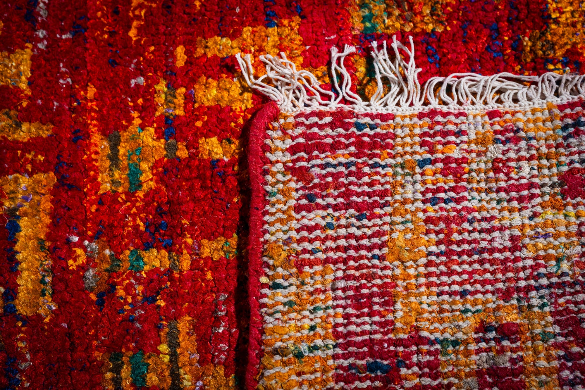Sari-silk red abstract Anand rug hand-knotted back and fringe detail