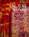 Sari-silk red abstract Anand rug hand-knotted back and fringe detail