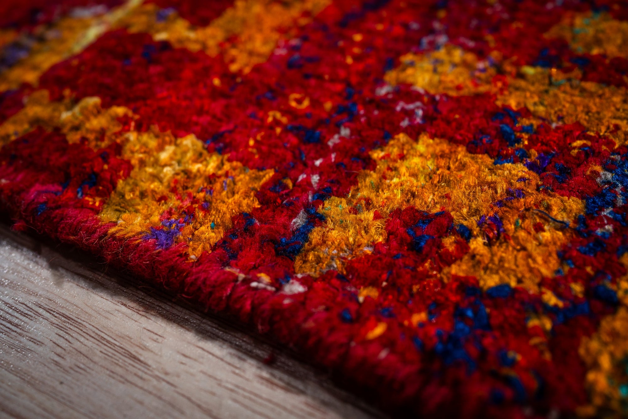 Sari-silk red abstract Anand rug edge and pile texture close-up