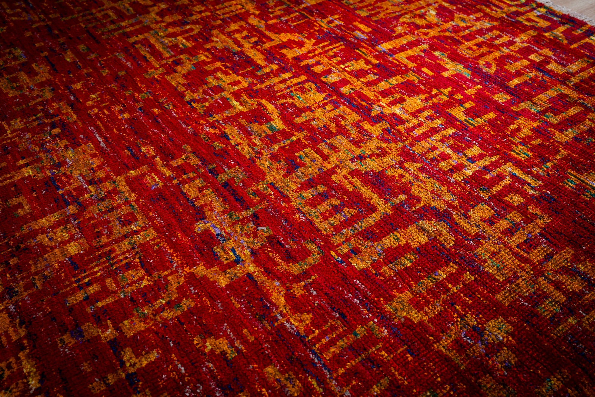 Sari-silk red abstract Anand rug angled field detail