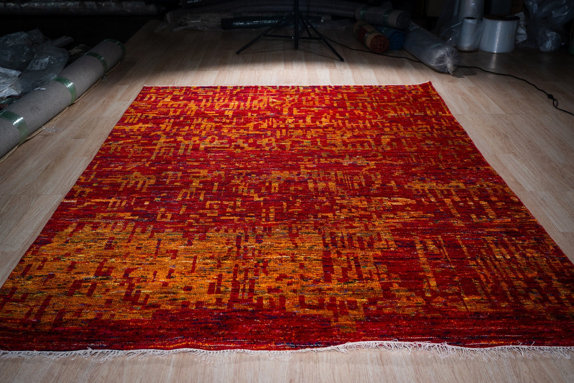 Hand-knotted sari-silk red abstract Anand rug, full view on the floor