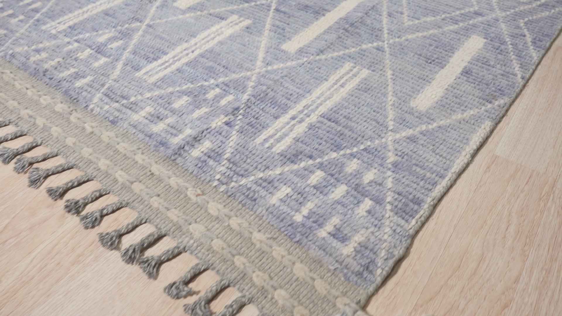 Timeless Marrakech Blue Hand-Knotted Wool Rug, displaying its intricate texture and blue hues within a softly lit room, suggesting warmth and comfort.