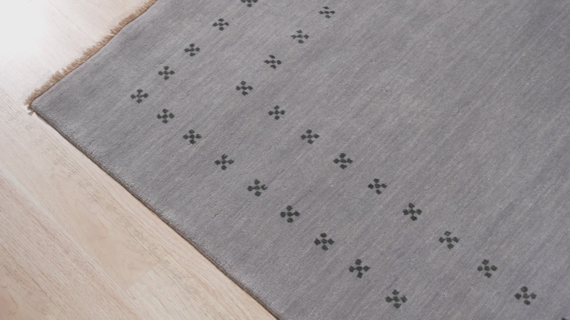 Here's the alt text based on the provided information:
 
 Jasmine Alluring Gray Handmade Wool Rug, displaying intricate patterns and soft gray hues, elegantly laid in a modern living space.