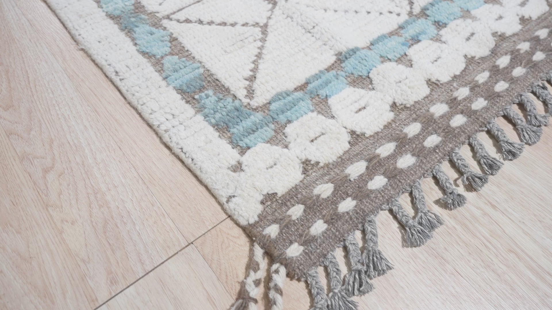 Timeless Marrakech Ivory Hand-Knotted Wool Rug, warm living room scene highlighting the rugâ€™s texture and subtle ivory tones under soft natural light.