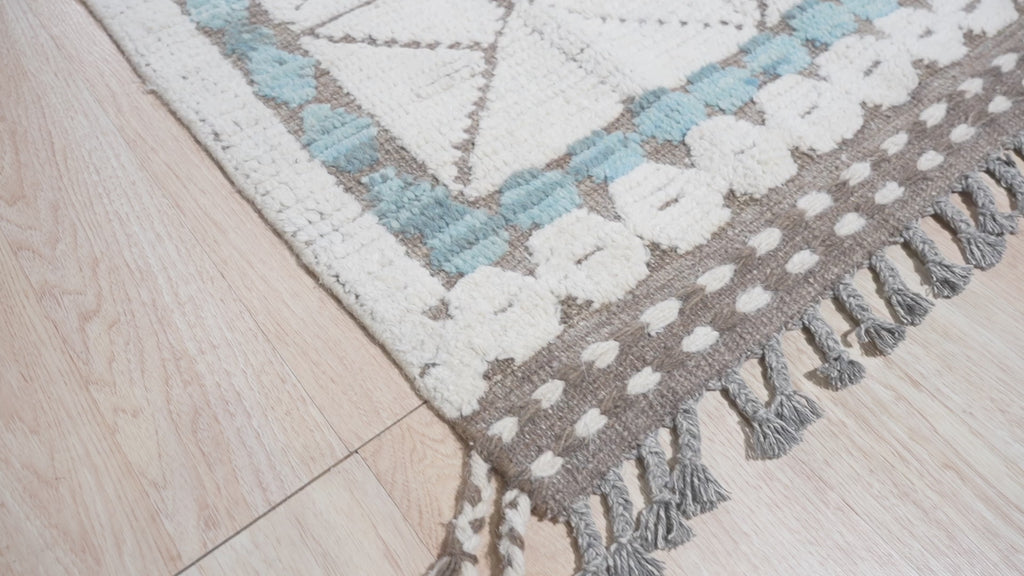 Timeless Marrakech Ivory Hand-Knotted Wool Rug, warm living room scene highlighting the rugâ€™s texture and subtle ivory tones under soft natural light.
